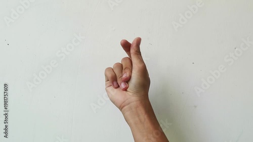 Close-up of a hand fingering against a plain white background