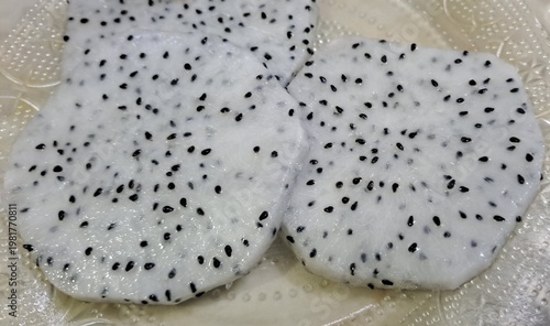 Dragon fruit slices on plate closeup 