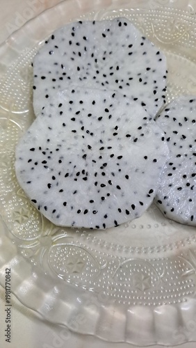 Dragon fruit slices on plate closeup 
