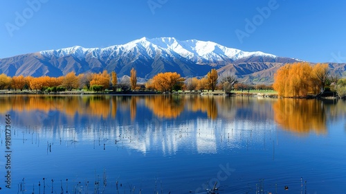 Serene Natural Landscape with Calm Lake and Snow-Capped Mountains
