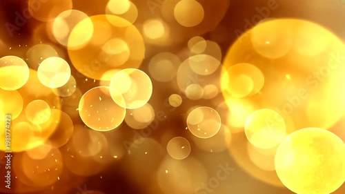 Bokeh lights shine in a warm gold background with smaller glowing specks dispersed