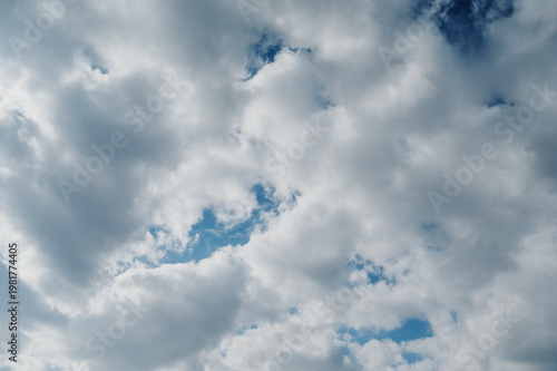 Snow-white clouds on a blue sky on a sunny summer day