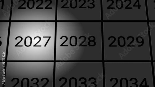 A cinematic camera zoom toward the year 2027 highlighted by a spotlight on a dark grid of consecutive years.
