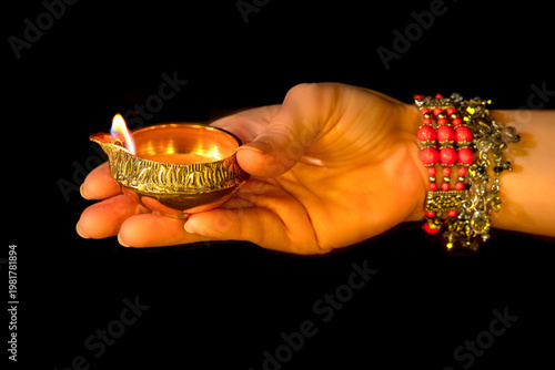 Fényképezés Hand with Diwali lamp diya or Deepavali or Deepawali
