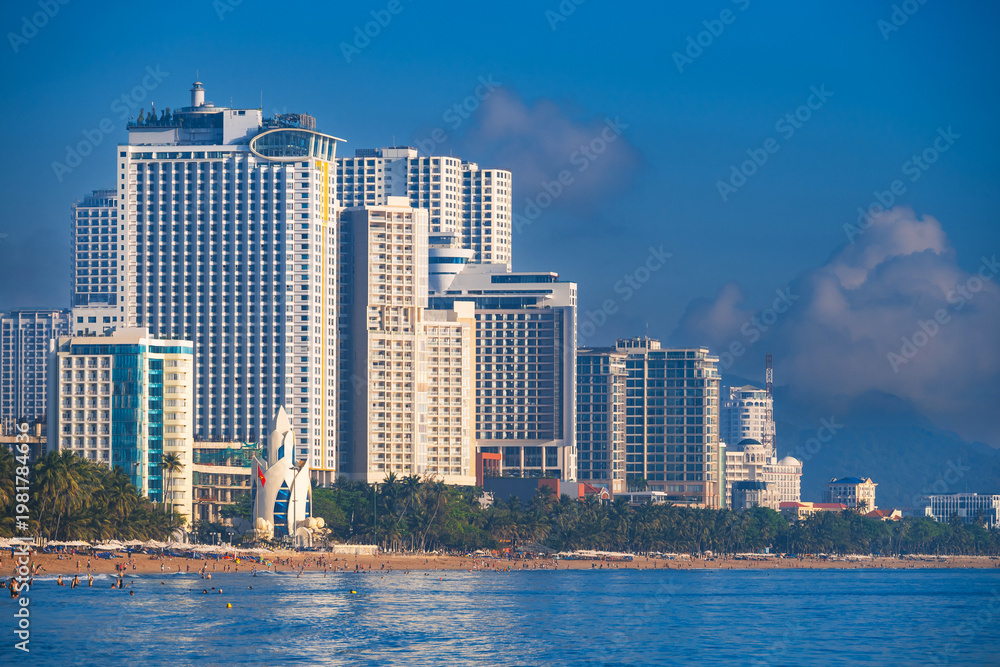 Fototapeta premium Panoramic view of the beach and skyscrapers in center of the tourist resort city of Nha Trang in Vietnam in Asia by the sea