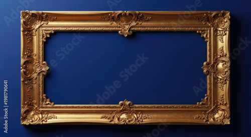 A large, ornate gold picture frame hangs on a dark blue wall.
