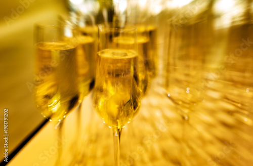 Guests enjoy exclusive cava in beautifully arranged glasses at a lavish gala event held in an upscale venue.