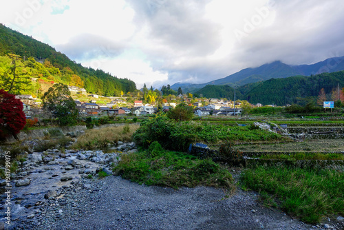 Rural valley village with river and mountains under dramatic clouds in Shikoku Japan