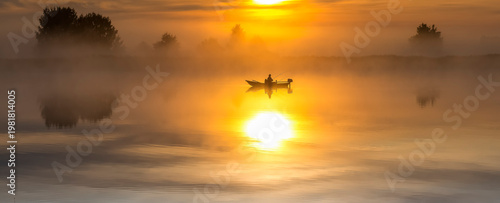 Awesome sunrise over a river or lake. Morning fog and reflections above calm water. Fishing fisherman from motor boat. Summer unusual and rare landscape. No AI tools were used