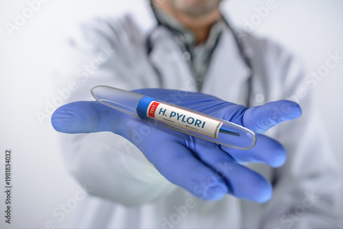 Doctor holds a test tube with Helicobacter Pylori test in his hand