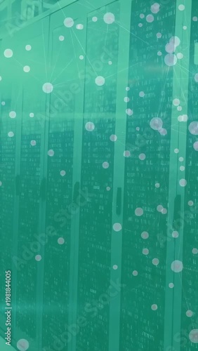 Vertical video: Camera panning row of racks, showing lights and cables, teal dots aiding IT ops