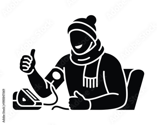 Man wearing winter clothing checks his blood pressure with a device and gives a thumbs up gesture