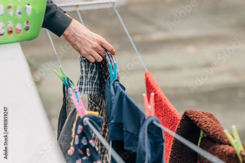 close-up of hands hanging out the laundry