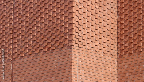 Modern brick facade with geometric relief pattern and architectural texture
