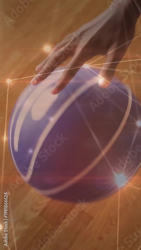 Vertical video: Opening with hand on purple ball, teen practicing dribbles on floor, wearing shorts