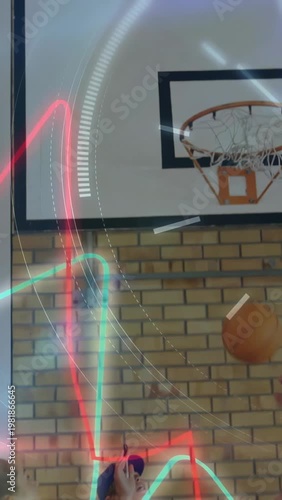 Diverse students, coach watching Chinese teen dunking basketball in school gym with neon overlay