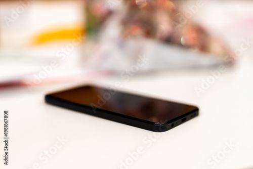 Contemporary smartphone placed on pristine white table with calming ambient glow
