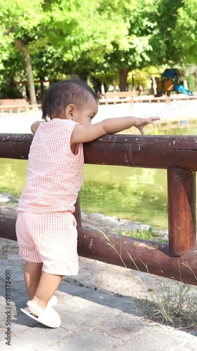 Curious baby girl exploring a public park