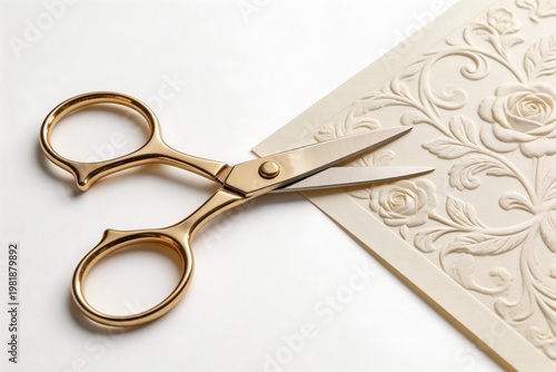 Gold scissors cutting embossed paper