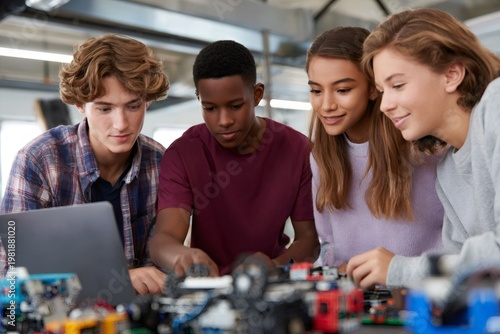 Diverse high school students collaborating on a robotics project. Teenagers working with a laptop in a STEM education class