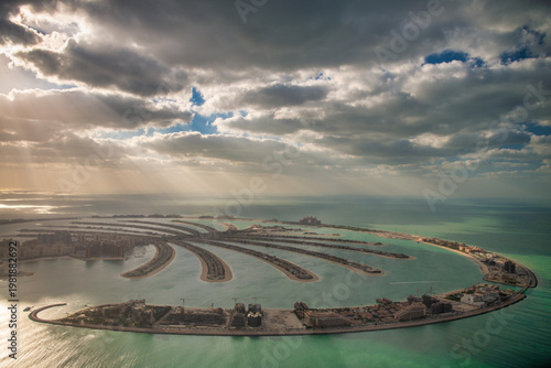 Wallpaper Mural Breathtaking aerial view of Palm Jumeirah Dubai at sunset with sunlight filtering through dramatic clouds Torontodigital.ca