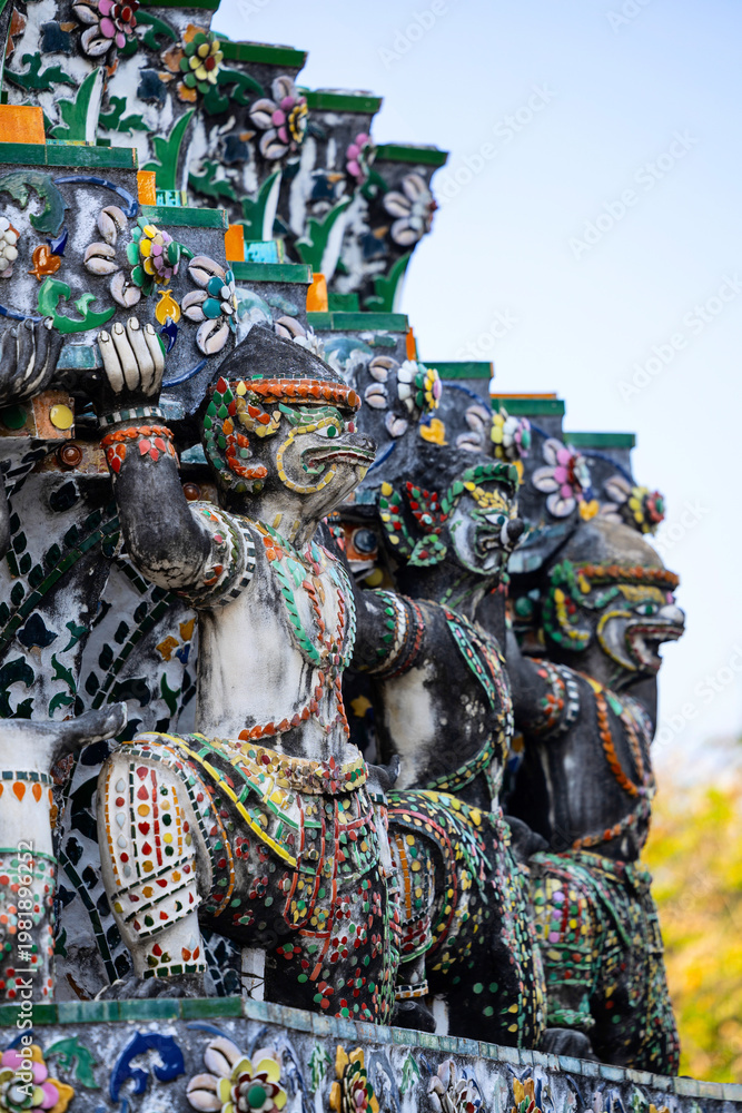 Fototapeta premium Colorful mosaic guardian statues on ornate temple wall