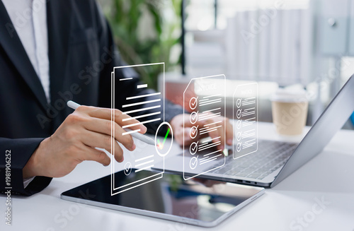 Businessman approving digital invoice on tablet and laptop, paperless billing system, e invoice management, and efficient online finance workflow.