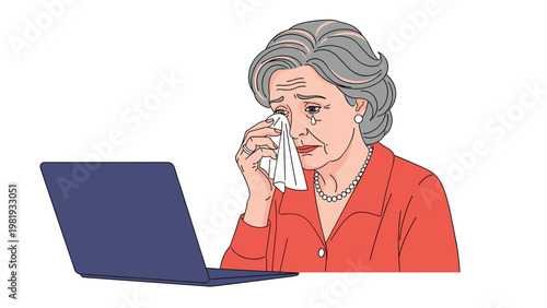 Elderly woman in a red sweater and pearls cries sadly while looking at her laptop screen with a tissue in her hand.