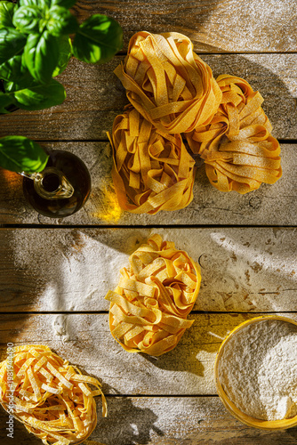 raw fettuccine on a wooden table with flour