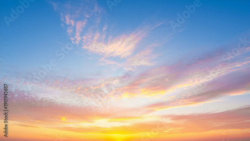 Принти на полотні Glowing yellow sunset with textured clouds over blue sky background atmosphere
