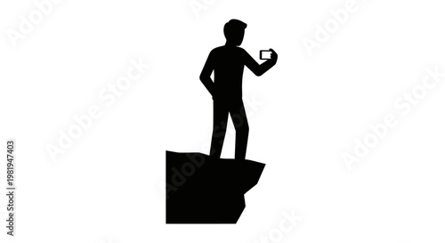Man standing on cliff edge holding phone.