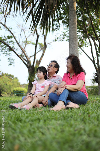 Ground Level Perspective of Senior Asian Family Relaxing Outdoors