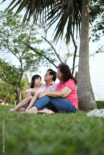 Ground Level Perspective of Senior Asian Family Relaxing Outdoors