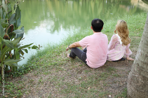 Couple Relaxing by the Pond