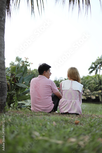 Vertical Portrait of Asian Couple Talking Outdoors with Sky Background