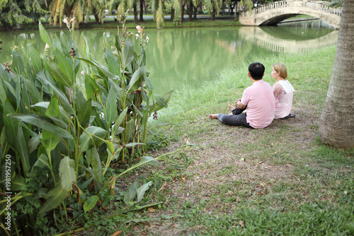 Wide Shot of Couple in Park with Bridge and Trees