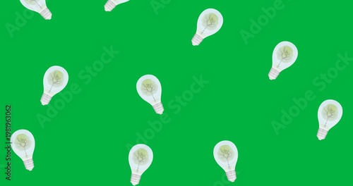 Tree in multiple light bulb icons falling against black background