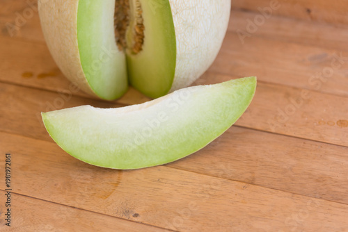 Fresh green melon on wood plate