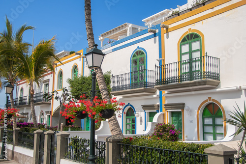 Colorful Canarian architecture with palm trees and balconies in Puerto de Mogán, Gran Canaria