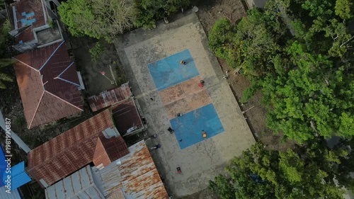 Children playing with toy cars on a basketball court. The scene shows fun outdoor activity, creativity, and joyful moments of childhood in a sports environment.