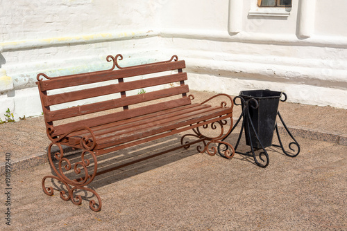 a wooden bench in the monastery courtyard on a sunny summer day