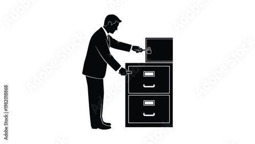 Businessman opening filing cabinet drawer.