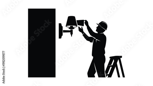 A worker installing a wall lamp.