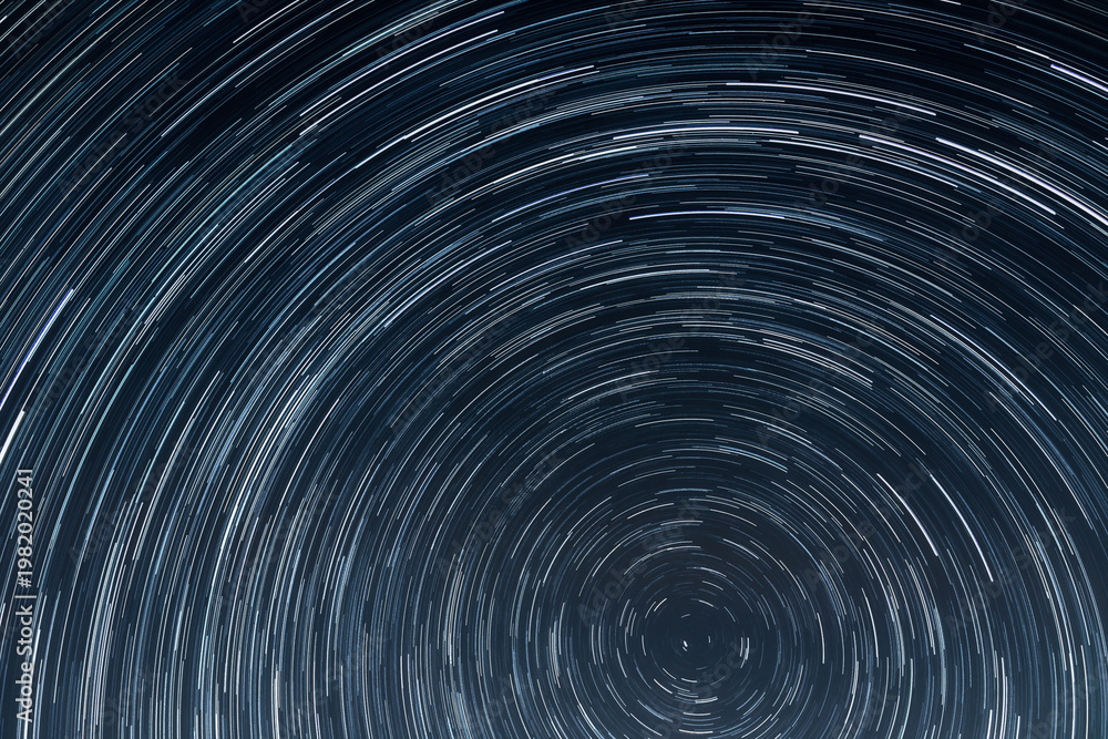 Fototapeta premium Concentric Star Trails Rotating Around the North Celestial Pole in Deep Blue Night Sky