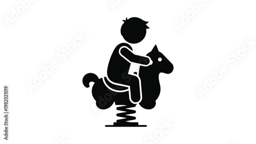 Black silhouette of a child playing on a spring rider toy horse.