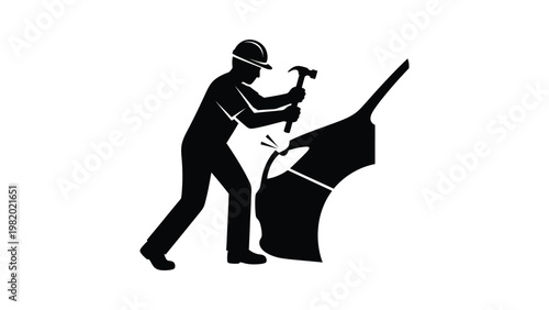 Worker using a hammer on a construction site.