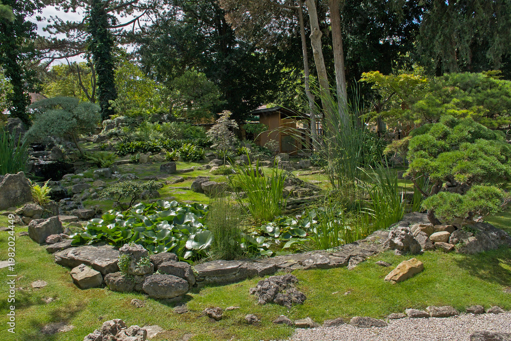 Naklejka premium Japanese garden with rocks and trees in the park of Schonbrunn palace, Vienna, Austria 