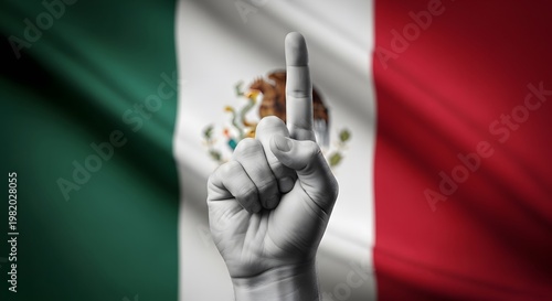 A grayscale hand with an index finger pointing up against a vibrant, waving Mexican flag, symbolizing unity or a vote.