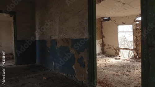 Slow Pan Through Abandoned Dilapidated Room with Peeling Blue Paint and Broken Windows in Derelict Building