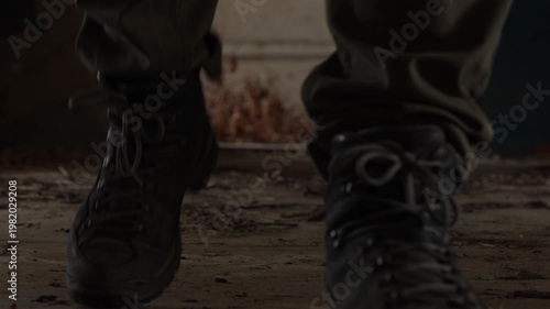 Close Up Low Angle View of Person in Tactical Boots and Cargo Pants Walking Through Abandoned Building
